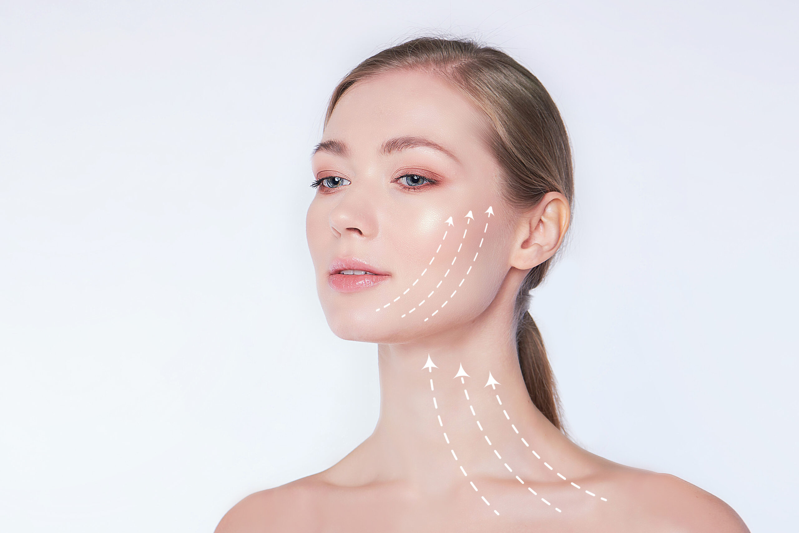 Close-up portrait of young, beautiful and healthy woman with arrows on her face spa