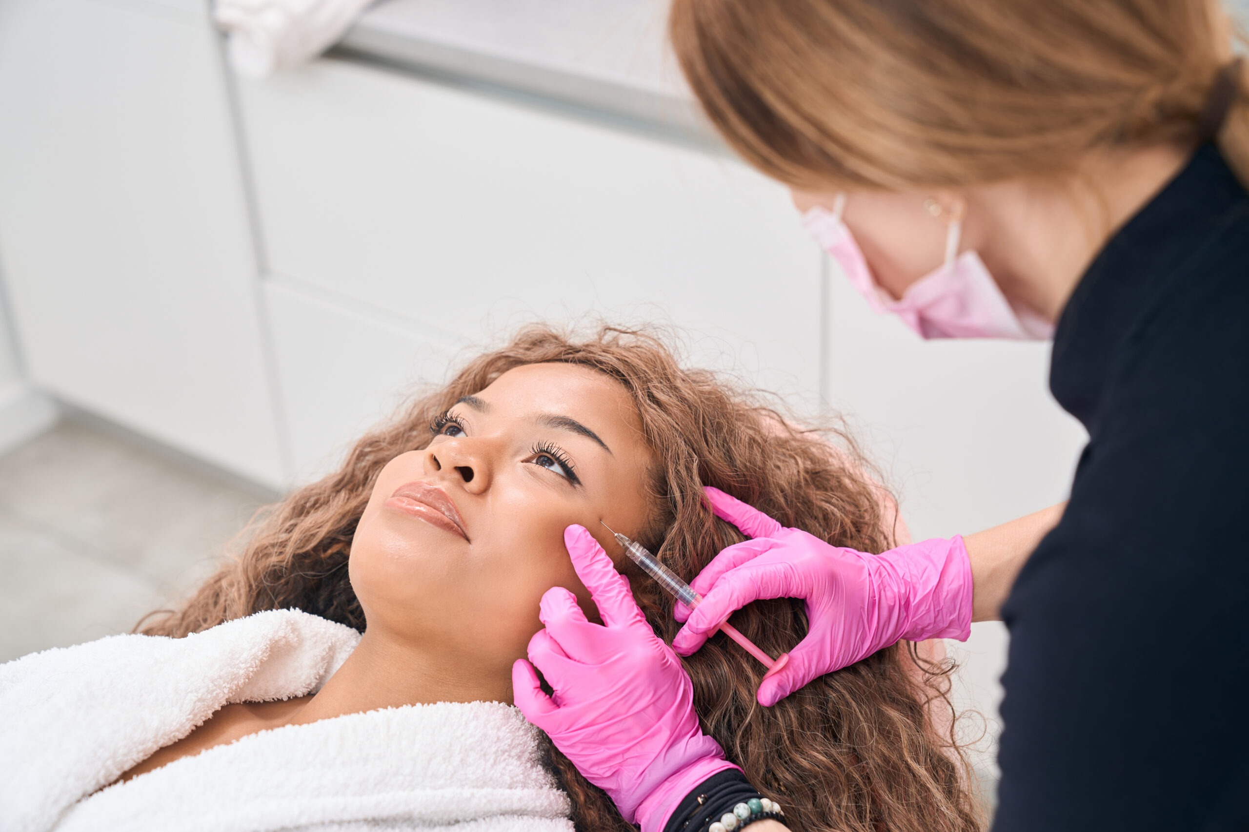 Doctor of aesthetic medicine makes injections of botulinum toxin